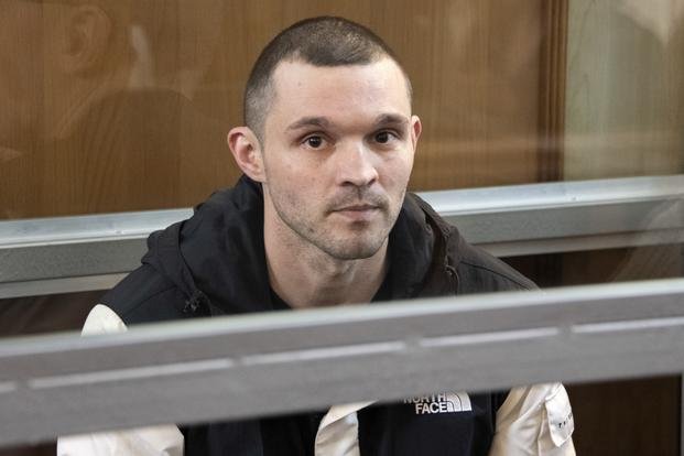U.S. Army Staff Sgt. Gordon Black sits in a defendant's cage in a courtroom in Vladivostok, Russia
