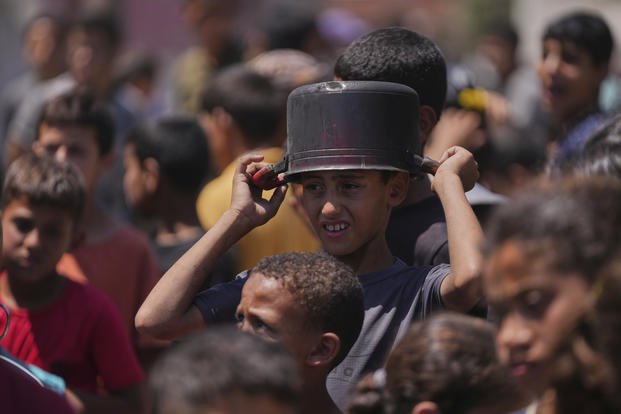 A young Palestinian waits to collect donated food.