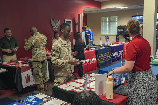 Representatives from colleges and universities present information at education fair