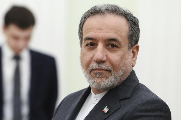 Iranian Foreign Minister Abbas Araghchi stands waiting