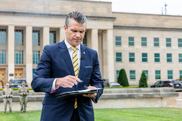 U.S. Secretary of Defense Pete Hegseth signs the ‘Unleashing U.S. Military Drone Dominance’ memorandum during a drone demonstration at the Pentagon.
