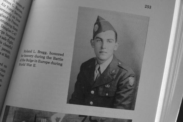 A military photo of Pfc. Roland L. Bragg is seen in a book about the history of Nobleboro, Maine.