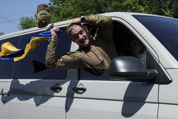 Ukrainian soldier Denys Zalizko, 21, greets his fellow villagers after returning from Russian captivity