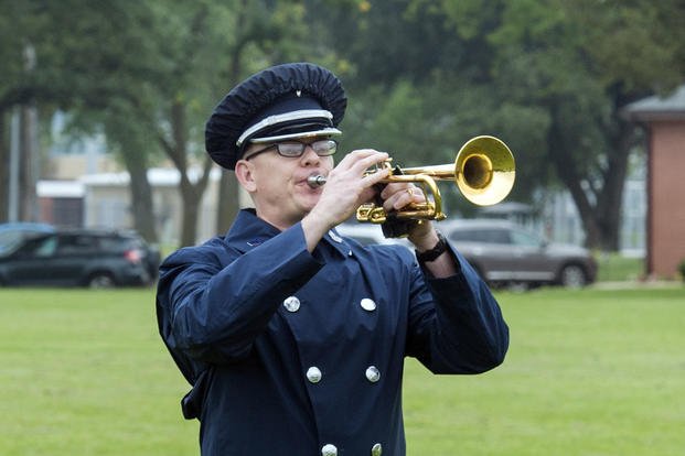 U.S. Air Force Staff Sgt. Daniel Thrower, Heartland of America Band hornist, plays ‘Taps’ during a remembrance ceremony at Offutt Air Force Base, Nebraska. 