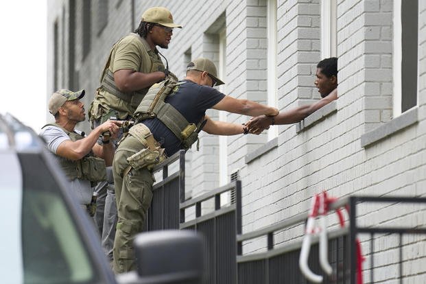 Armed Officers place handcuffs on a man northwest Washington DC