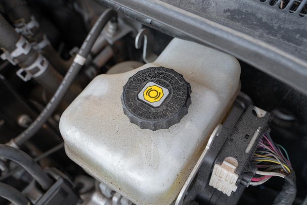 Your brake fluid reservoir will tell you what type of fluid to use; in this case, it’s DOT 3 or DOT 4 brake fluid.