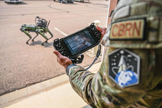 U.S. Air Force Master Sgt. Dominic Garcia operates the Chemical, Biological, Radiological, and Nuclear Quadrupedal Unmanned Ground Vehicle, named CHAPPIE, on Buckley Space Force Base, Colorado.