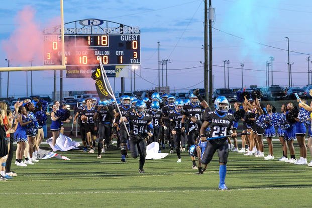 The Fort Campbell Falcons run onto the field before facing the Fort Knox Eagles at Fryar Stadium on Fort Campbell, Ky., for the 50th meeting between the football teams.