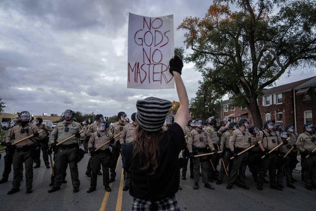 A demonstrator holds a sign