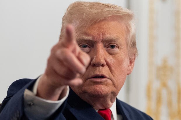 President Donald Trump points at reporters. 