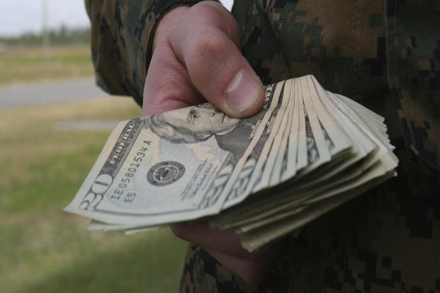 Soldier Holding Special Monthly Compensation Payment 