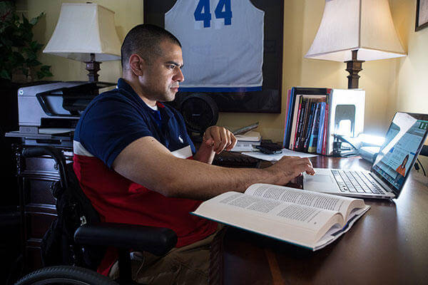 Veteran in a wheelchair in a dorm