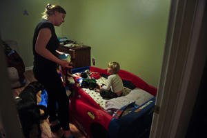 Heather Drain putting her son to bed.