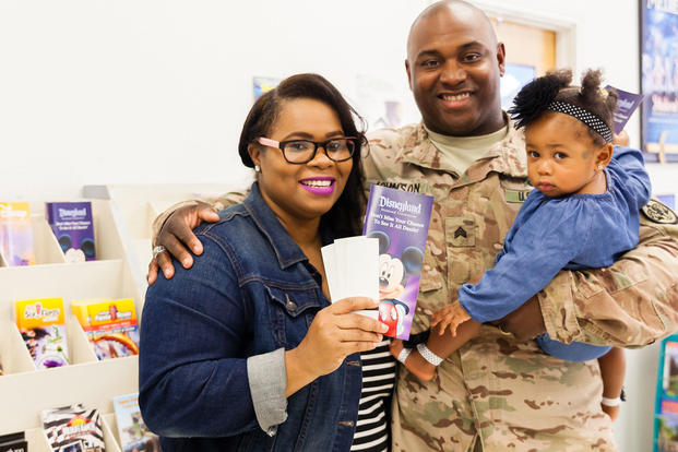 An Army soldier with his wife and daughter looking at vacation brochures (Photo: U.S. Army MWR)