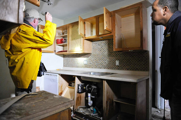 A home inspector examines a kitchen
