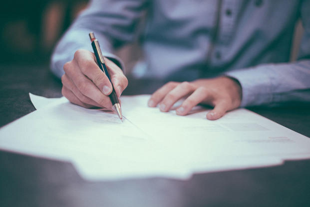 Man signing paperwork