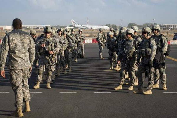 Soldiers of the East Africa Response Force (EARF), a Djibouti-based joint team assigned to Combined Joint Task Force-Horn of Africa, prepare Dec. 18 to load onto a U.S. Air Force C-130 Hercules at Camp Lemonnier, Djibouti.