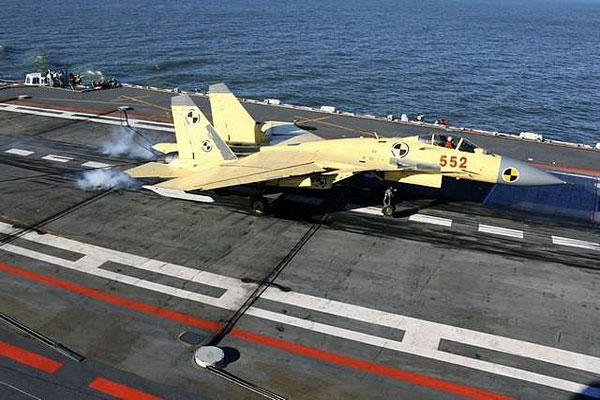 In this undated photo released by China's Xinhua News Agency, a carrier-borne J-15 fighter jet lands on China's first aircraft carrier, the Liaoning. /AP