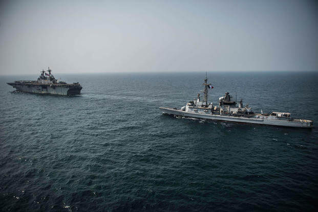 The Wasp-class amphibious assault ship USS Essex (LHD 2) transits in formation with the French Marine Nationale anti-aircraft frigate Frigate FS Cassard (D 614) during an interoperability exercise between the nations. (Photo by Mass Communication Speciali