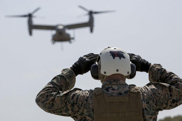 U.S. Marine Corps Lance Cpl. Mackinnly Lewis guides an MV-22B Osprey during a helicopter support team exercise at Naval Station Rota, Spain, July 6, 2016. (Photo: Staff Sgt. Tia Nagle)