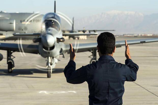 A member of the Afghan Air Force marshals in an A-29 Super Tucano at Hamid Karzai International Airport, Afghanistan. (US Air Force/Nathan Lipscomb)