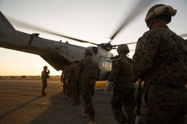 Marine Infantry Officer Course students approach a CH-53E Super Stallion helicopter on the Marine Corps Air Station Yuma, Ariz., Auxiliary Landing Field 2, Wednesday, August 18, 2014. (Cpl. James Marchetti/U.S. Marine Corps)