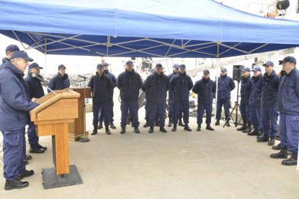 Rear Adm. Daniel Able, commander First Coast Guard District, addresses the crew of the 110-foot patrol boat Bainbridge Island during a ceremony at the cutter’s pier in Bayonne, N.J., March 17, 2014.