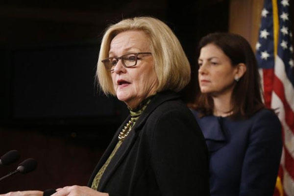 This March 6, 2014 file photo shows Sen. Claire McCaskill, D-Mo., left, and Sen. Kelly Ayotte, R-N.H. at a news conference on Capitol Hill in Washington. (AP Photo/Charles Dharapak, File)
