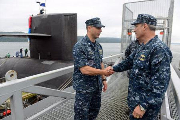 Navy Rear Adm. Dietrich Kuhlmann, the commander of Submarine Group 9, right, congratulates the USS Pennsylvania’s “Gold” crew commanding officer Navy Cmdr. Tiger Pittman, left. (U.S. Navy photo)