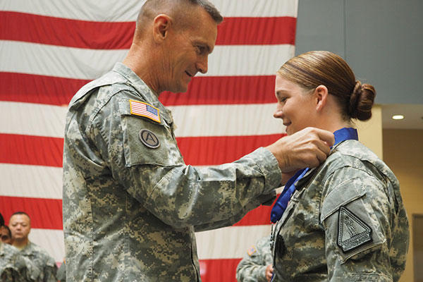 New York Army National Guard Major Gen. Patrick Murphy presents the New York State Medal for Valor to Staff Sgt. Marlana Watson. (U.S. Army/Sgt. J.P. Lawrence)
