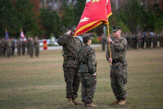 Lt. Col. David Morris passes the battalion colors to Lt. Col. Lauren Edwards during the 8th Engineer Support Battalion change of command ceremony at Camp Lejeune, N.C., Nov. 30, 2015. (Photo: Cpl. Ryan Young)