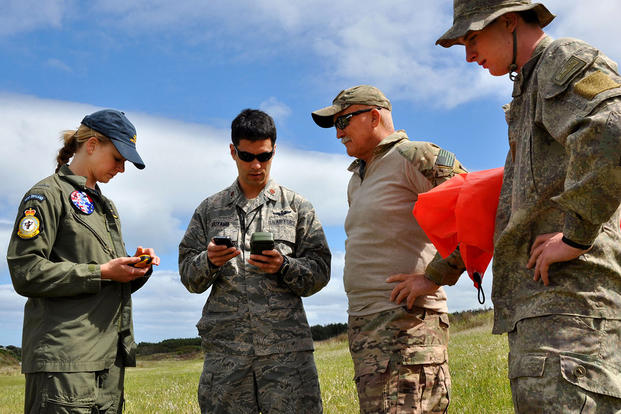 Royal New Zealand Air Force Pilot Officer Emma Taylor checks wind velocity and direction as part of the requirements to earn her United States drop zone safety officer certification. (U.S. Air Force/Senior Master Sgt. Denise Johnson)