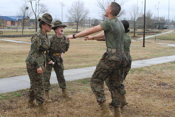 Two drill instructors with P Company, 4th Recruit Training Battalion, Marine Corps Recruit Depot Parris Island, S.C., yell at U.S. Marine Corps Pvt. Olivia K. Downing and U.S. Marine Corps Pfc. William A. Crouch. (Photo: Sgt. Dwight Henderson)