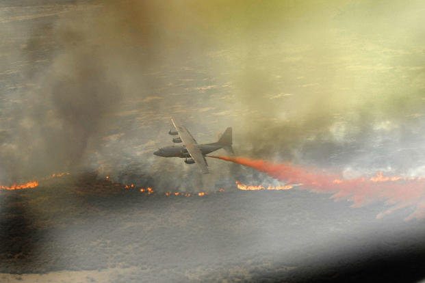A C-130 Hercules, equipped with the Modular Airborne Firefighting System, drops fire retardant April 27, 2011, above West Texas. Staff Sgt. Eric Harris/Air Force