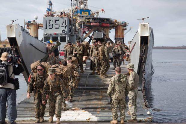 U.S. Marines with the 26th MEU exit U.S. Navy Landing Craft, Utility 1654 to assist in support relief efforts for victims of Hurricane Maria in Ceiba, Puerto Rico, Sept. 25, 2017. (U.S. Marine Corps/Lance Cpl. Alexis C. Schneider)