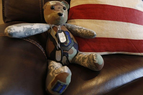 This Dec. 16, 2014, photo shows a stuffed animal wearing the dog tags of the late Army Major Chad Wriglesworth on the chair where he died in Bristow, Va. Wriglesworth died of cancer after returning from deployment in Afghanistan. Steve Helber/AP