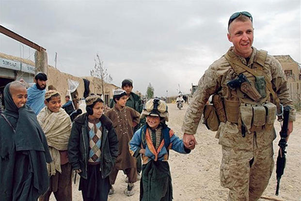 Jason Brezler with Afghan children. Cpl. Zachary Nola/Marine Corps