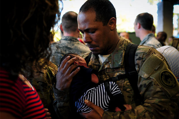 Staff Sgt. Michael Mayo holds his newborn for the first time during Operation Homecoming at Hurlburt Field, Fla., Nov. 6, 2015.  (Photo: U.S. Air Force/Senior Airman Meagan Schutter)