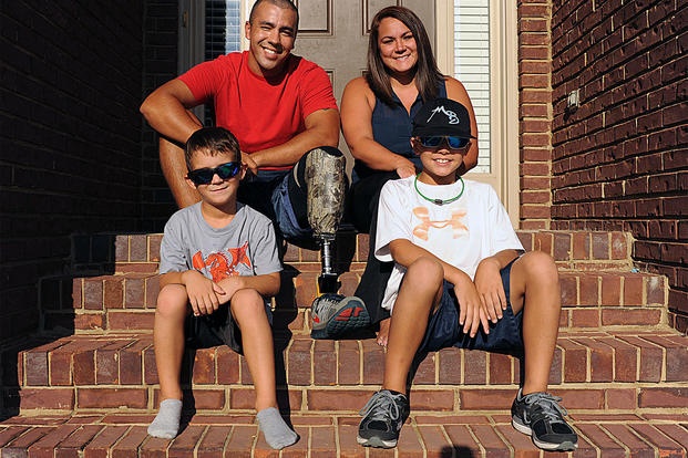 Staff Sgt. Rey Edenfield poses with his wife, Amy, and their two sons, Grayson, left, and Dawson on the front porch of their home. Edenfield is an air traffic controller at Maxwell Air Force Base, Alabama. (U.S. Air Force /Staff Sgt. Erica Picariell)