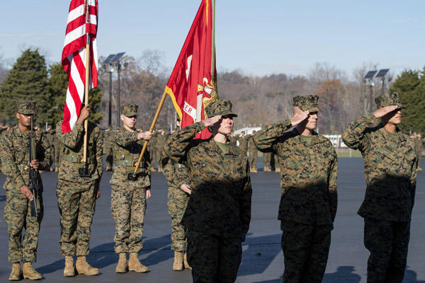 Candidates in Officer Candidate School salute during the 75th anniversary OCS ceremony at the Marine Corps.