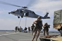 Marines from the 22nd MEU fast rope to the flight deck from a MH-60S Sea Hawk helicopter during an exercise aboard the USS Whidbey Island. Mass Communication Specialist 3rd Class Desiree D. Green/Navy