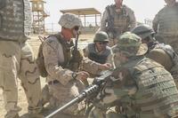 A U.S. Marine advisor with Task Force Southwest demonstrates proper firing techniques on a M2 Browning .50 Machine Gun to Afghan National Army soldiers during a live-fire range at Camp Shorabak, Afghanistan, Aug. 17, 2017.. (U.S. Marine Corps/Sgt. Lucas Hopkins)