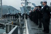 Sailors man the rails on the flight deck of the U.S. Navy's only forward-deployed aircraft carrier, USS Ronald Reagan (CVN 76), as the ship pulls into Busan for a scheduled port visit (U.S. Navy/Petty Officer 2nd Class Kenneth Abbate/Released)