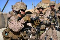 Women Marines check their rifles after a patrol in Helmand Province, Afghanistan while on deployment in June 2012. (US Marine Corps photo)