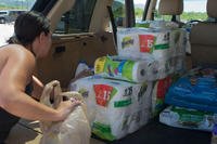 Jennifer LaBreche loads items into the back of a vehicle outside the Orote Commissary at Naval Base Guam on Oct. 21, 2017. (U.S. Navy photo by Lt. Lauren Spaziano)