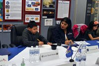 Chrissy Quintero, Army &amp; Air Force Exchange Service inventory specialist, helps third-grader Juan David Rodea give feedback on a meal option under consideration for overseas Department of Defense school. (AAFES)
