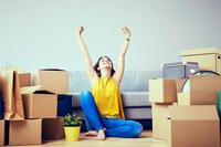 Woman with couch and moving boxes