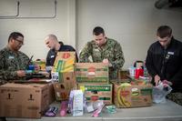 Sailors assigned to the Los Angeles-class fast-attack submarine USS Olympia (SSN 717) sort through donated food items for the Thurston County Food Bank in downtown Olympia, Wash., March 17. (U.S. Navy/Mass Communication Specialist 2nd Class Nancy C. diBenedetto)