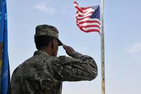A soldier salutes the U.S. flag during the singing of the national anthem on Sept. 11, 2017, at Camp Arifjan, Kuwait. (Sgt. Kimberly Browne/U.S. Army photo)