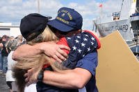 Petty Officer 1st Class Evan Means, a crewmember aboard the Coast Guard Cutter Resolute, hugs a family member after returning home to St. Petersburg, Florida (U.S. Coast Guard/Ashley J. Johnson)